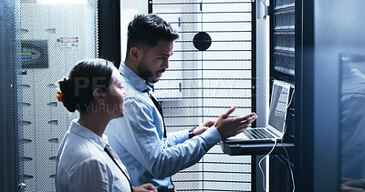 Buy stock photo Conversation, laptop and problem solving with people in server room for network administration. Collaboration, computer and cybersecurity with IT support team in data center for troubleshooting