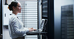 Laptop, typing and woman in server room for engineering, network maintenance or programming. Administration, computer and cybersecurity with IT professional in data center for firewall installation