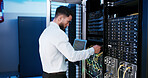 Man, laptop and cable inspection in server room, system or coding process for IT solution at company. Person, cybersecurity and assessment with computer, hardware and information technology at agency