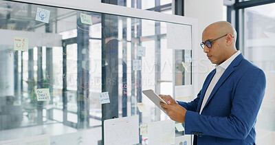 Buy stock photo Businessman, tablet and glass wall for finance, research or brainstorming in office for strategy. Report, employee and technology with sticky note, feedback or schedule tasks for investment project