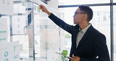 Buy stock photo Businessman, tablet and sticky note for finance, planning or brainstorming in office for strategy. Glass wall, employee and technology with budget, review or schedule tasks for investment project