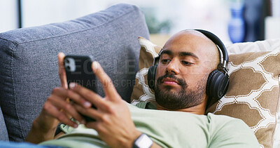 Buy stock photo Relax, headphones and sofa with man and phone for streaming service, calm audio and ambient sound. Guided podcast, white noise and peace playlist with person in living room of home for break