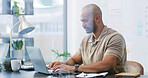 Creative, employee and man with laptop, office and serious for ad campaign on web, typing or online. Business, marketing manager and person with tech for research, planning and review of social media