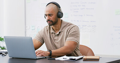 Buy stock photo Laptop, headphones and man in office with music, playlist or podcast for working on creative project. Audio tech, computer and person streaming album and typing for article with publishing at agency.