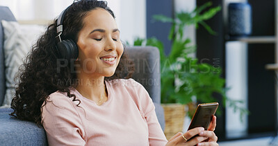 Buy stock photo Relax, headphones and smile with woman and phone for streaming service, calm audio and ambient sound. Guided podcast, white noise and peace playlist with person in living room of home for break