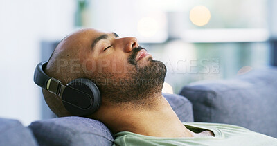 Buy stock photo Relax, headphones and eyes closed with man on sofa for streaming service, calm audio and ambient sound. Guided podcast, white noise and peace playlist with person in living room of home for break