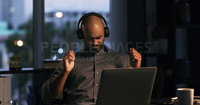 Buy stock photo Dance, headphones and businessman in office at night with laptop for listening to music or playlist. Bokeh, audio tech and creative editor with album and working on article for publishing deadline