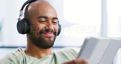 Buy stock photo Happy man, headphones and tablet to relax for streaming media and entertainment app. Smile, music platform and male person on technology in home for audio book, podcast and news blog in living room