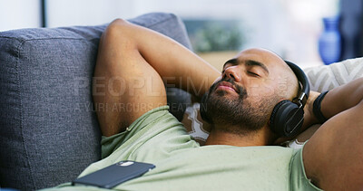 Buy stock photo Eyes closed, headphones and peace with man on sofa for streaming service, calm audio and ambient sound. Guided podcast, white noise and playlist with person in living room of home for break and radio