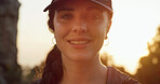Portrait, woman and hiking with sunset for journey, smile and environment for travel destination. Female person, eco tourism and relax for trekking, outdoor and holiday for nature adventure hobby