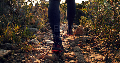 Buy stock photo Legs, person and hiking on rocks for fitness, travel path and trekking adventure to explore nature. Feet, shoes and walking on trail with fresh air, mountain route and physical hobby for holiday trip