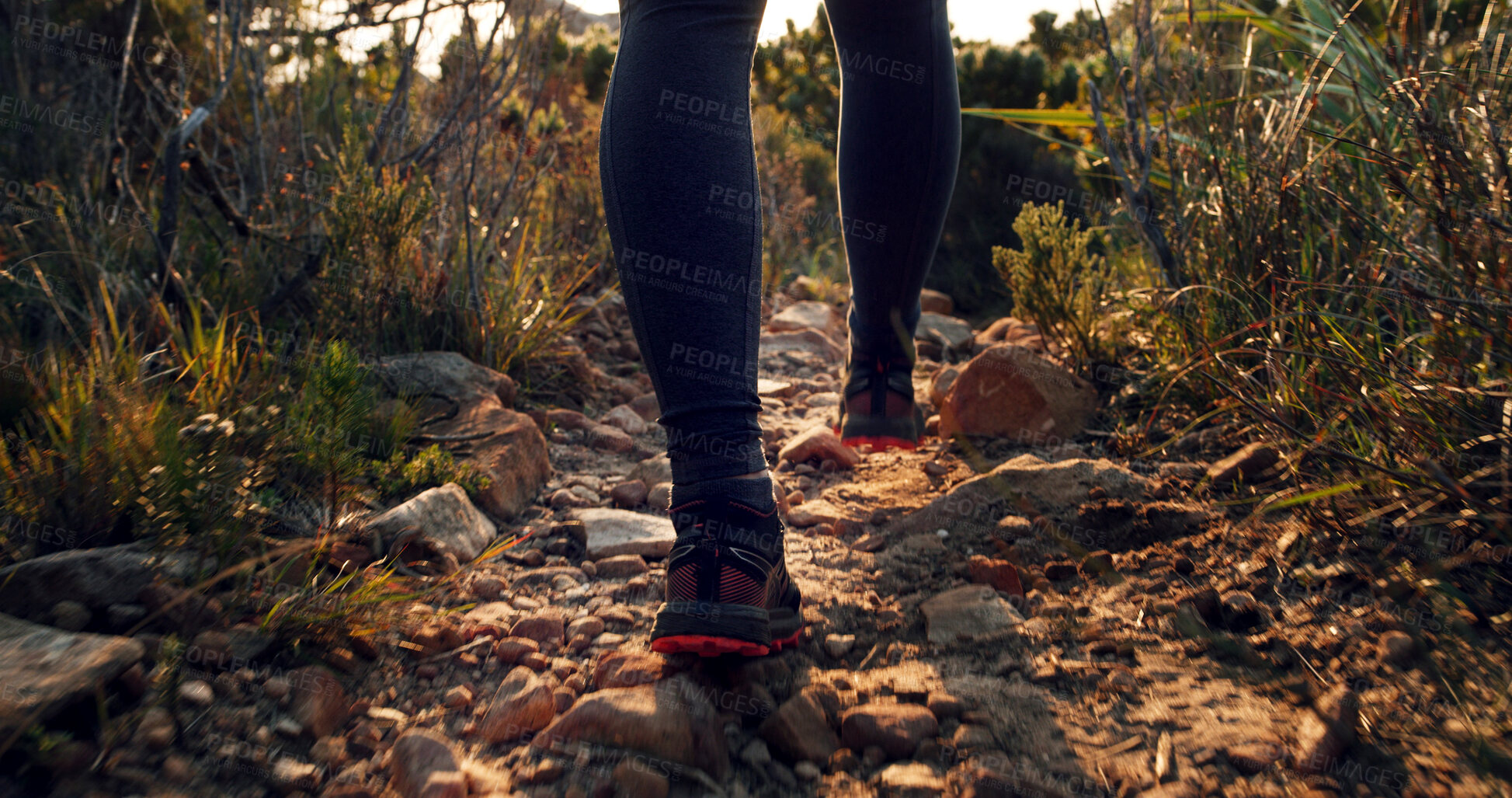 Buy stock photo Legs, person and hiking on rocks for fitness, travel path and trekking adventure to explore nature. Feet, shoes and walking on trail with fresh air, mountain route and physical hobby for holiday trip