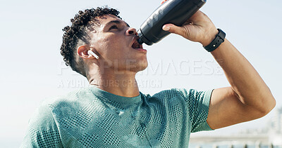Buy stock photo Drinking water, outdoor and man with fitness, hydration and break with wellness, exercise and training. Healthy person, thirsty and runner with mineral drink, liquid and morning workout with rest