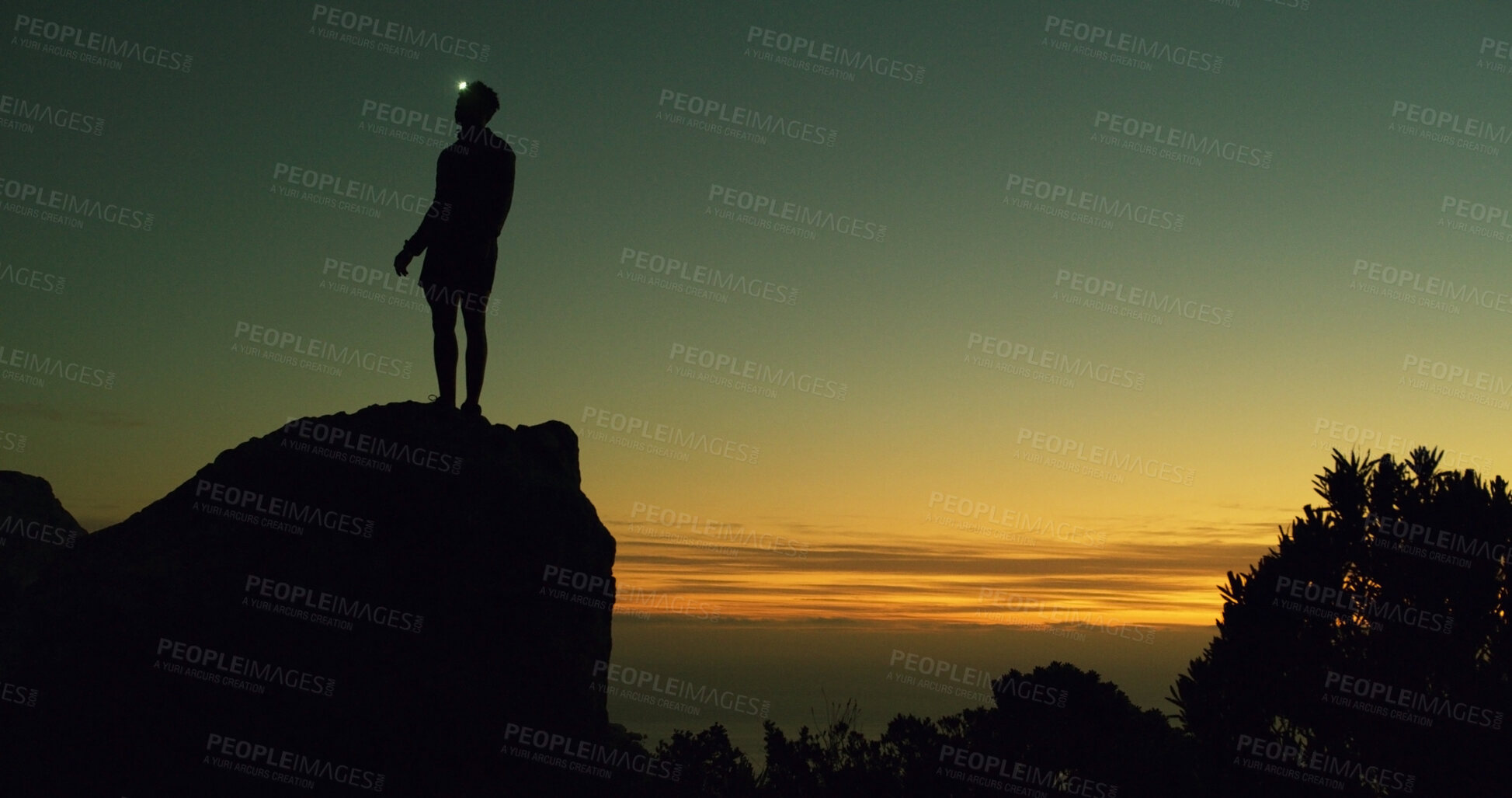 Buy stock photo Night, rock climber and break in nature, adventure and person on cliff with headlamp and silhouette. Outdoor, space and athlete on mountain for fitness, sunset and light for exploration in dark