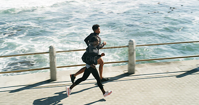 Buy stock photo Workout, people and running at beach promenade for burning calories, endurance or cardio routine. Above, athlete or trainer jogging at ocean for pace training, marathon exercise or fitness challenge