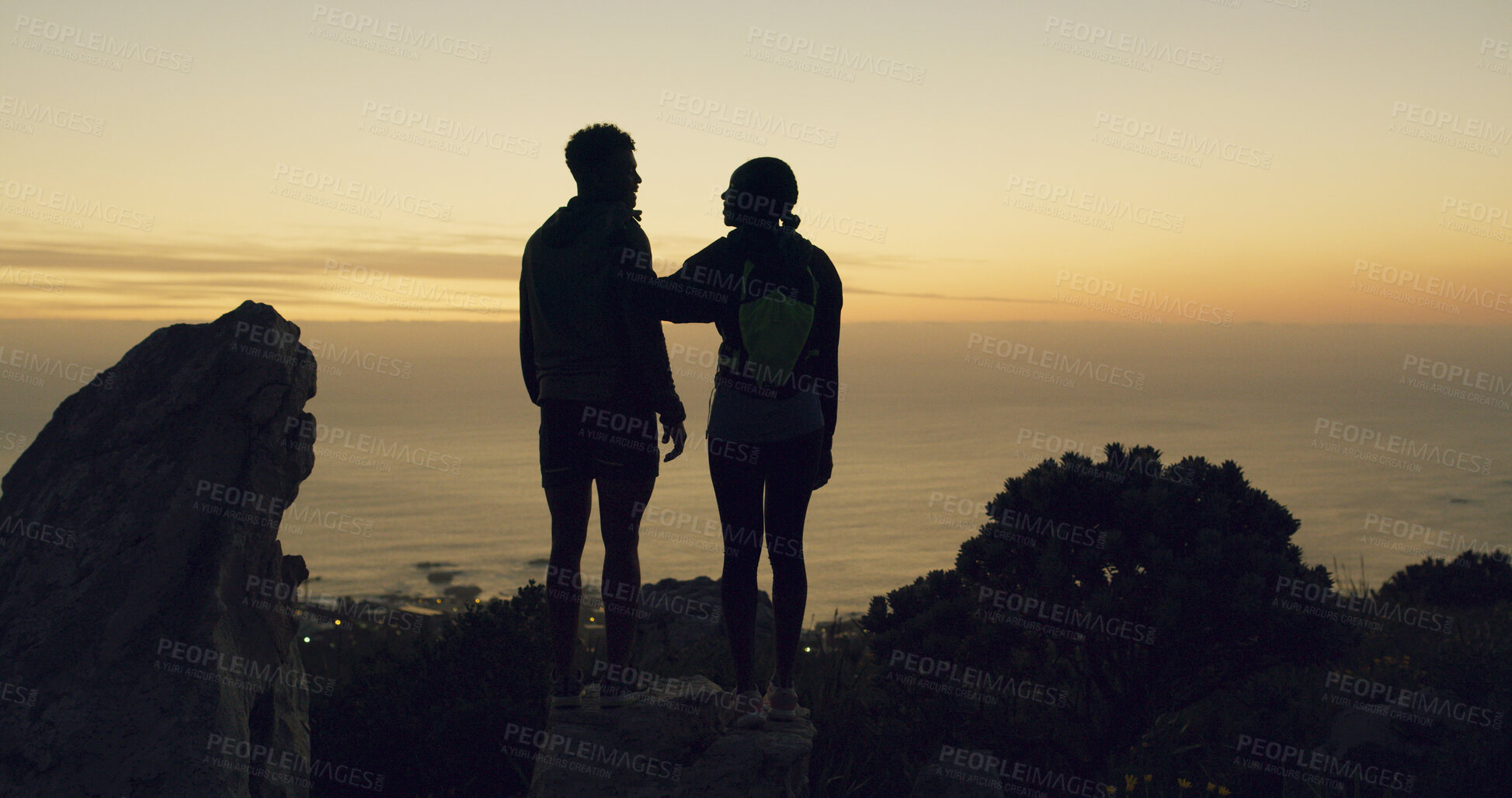 Buy stock photo Sunset, couple and mountain with hiking for view, ocean and fitness together with adventure in nature. People, evening exercise and trekking peak for travel, exploring outdoor for bonding or wellness