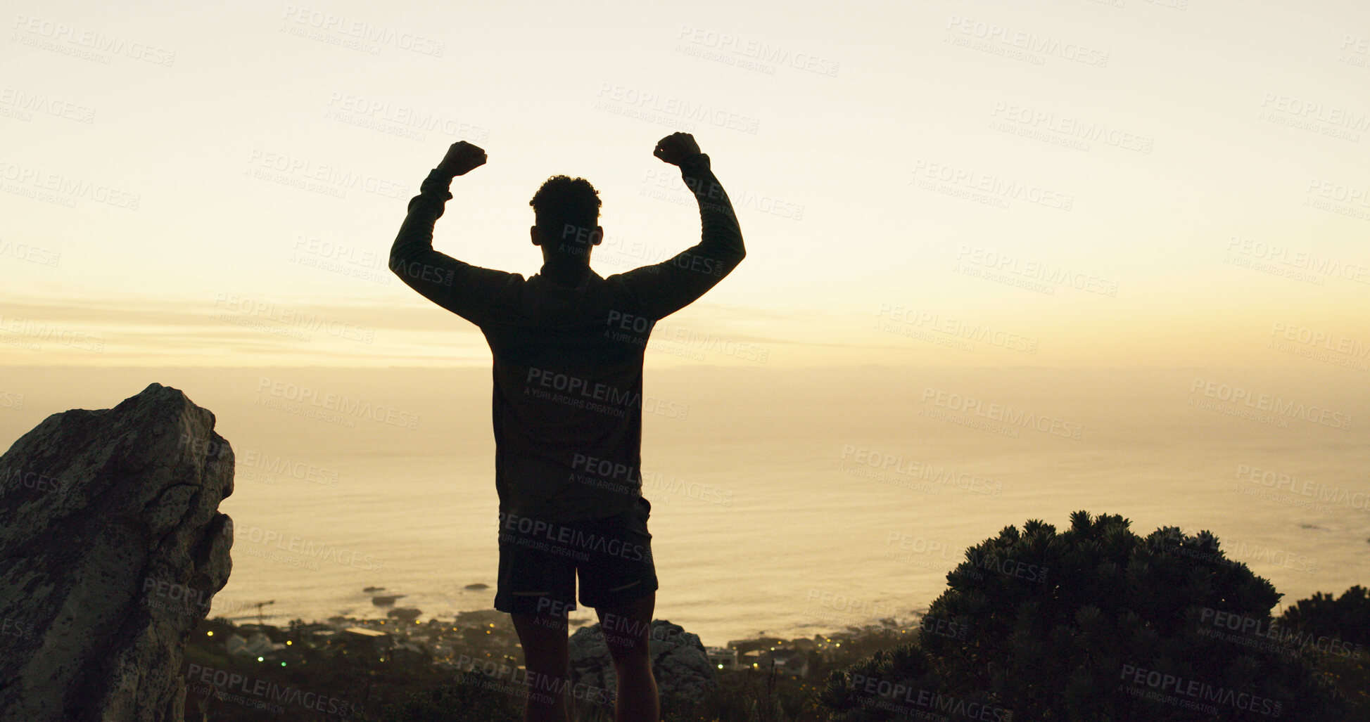 Buy stock photo Silhouette, man and winning with fist pump on mountain for conquer, achievement or accomplishment. Active, male person or back view with sunset in celebration for hiking success or milestone on space