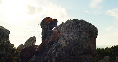 Buy stock photo Rock, hiking and climbing with man in nature for trekking, adventure and summer vacation. Explore, backpacking and mountain summit with person outdoor for sunrise, freedom and low angle space