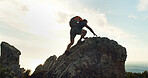 Climbing, hiking and travel with man in nature for trekking, adventure and summer vacation. Explore, backpacking and mountain summit with person on cliff for rock, freedom and holiday tourism
