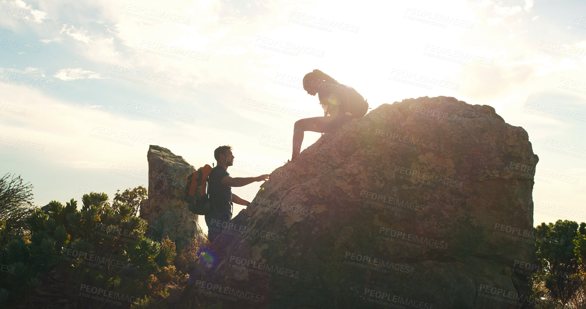 Buy stock photo Cliff, hiking and support with couple in nature for trekking, adventure and summer vacation. Explore, backpacking and mountain summit with people outdoor for sunrise, freedom and tourism space