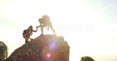 Buy stock photo Friends, helping hand and fitness on mountain for countryside, travel or adventure to explore nature. Outdoor, people and mockup with flare and assistance for hiker, hobby and bonding together