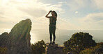Woman, binoculars and hiking on mountain, sky and gear for sightseeing, birdwatching or adventure. Person, view and lens for landmark, outdoor and thinking with trekking on trail in summer in Spain