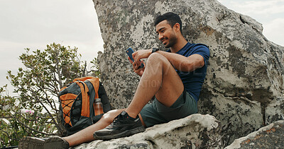 Buy stock photo Man, phone and texting on mountain, hiking and rest with backpack, break and check route on digital map. Person, smartphone and happy with mobile app for direction, trekking or social media on rock