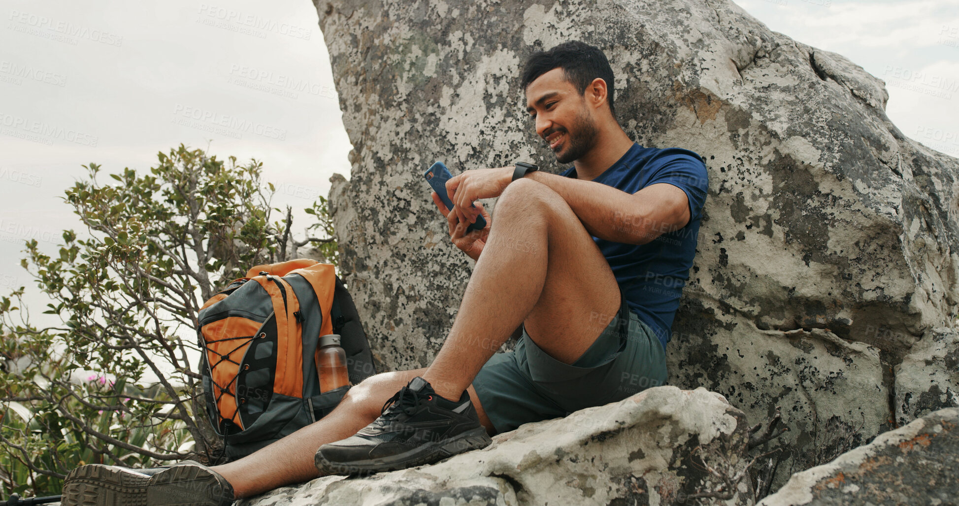 Buy stock photo Man, phone and texting on mountain, hiking and rest with backpack, break and check route on digital map. Person, smartphone and happy with mobile app for direction, trekking or social media on rock