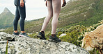 Woman, legs and mountain with rock for hiking journey, fitness or outdoor exercise together. Female people, friends or shoes on nature path for trekking adventure, footwear or travel in wilderness