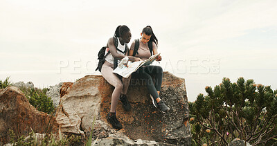 Buy stock photo Women, map and hiking with talk on mountain, point and search for direction on trail for tourism. Girl, friends and chart for route, trekking and outdoor on adventure, location or landmark in summer
