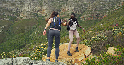 Buy stock photo Friends, women and helping on mountain for countryside, travel or adventure to explore nature. Fitness, people and journey with natural environment for hiker, trekking hobby and holding hands