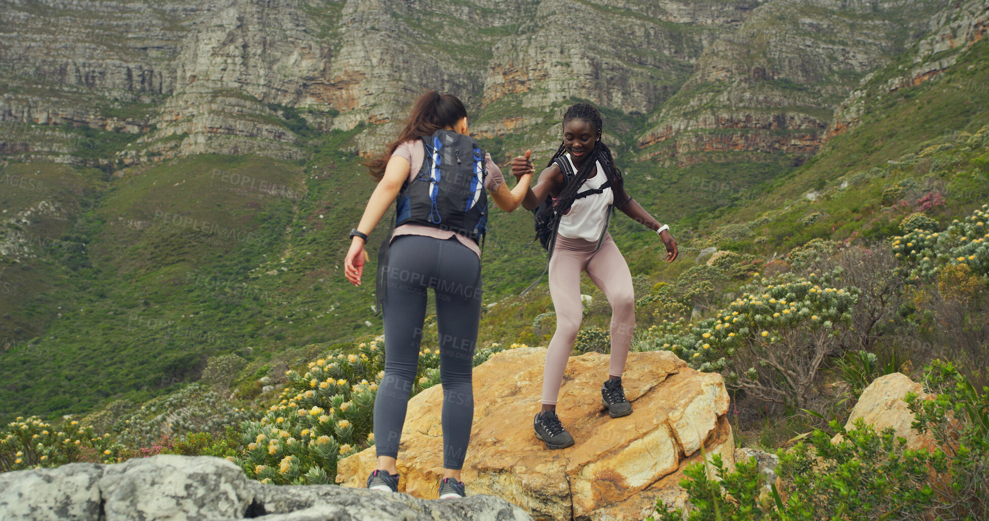 Buy stock photo Friends, women and helping on mountain for countryside, travel or adventure to explore nature. Fitness, people and journey with natural environment for hiker, trekking hobby and holding hands