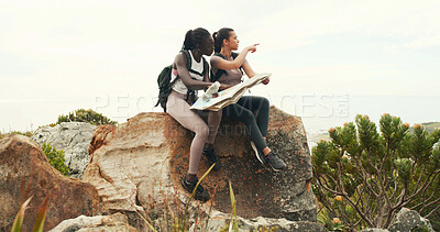 Buy stock photo Women, map and hiking with point on mountain, talk and search for direction on trail for tourism. Girl, friends and chart for route, trekking and outdoor on adventure, location or landmark in summer