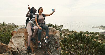Buy stock photo Girl, friends and hiking with selfie on mountain, excited and memory with peace sign in nature. Women, happy and photography for profile picture, trekking or social network for adventure in summer