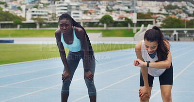 Buy stock photo Women, athlete and tired with smart watch on track for workout, smile and teamwork for speed record. Girl, exhausted runner and check stopwatch with training partner, happy and fatigue at sports club