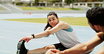 Runner, woman or stretching legs with friends on race track for health, wellness or fitness. Sports, athlete and warm up hamstring on field at stadium for exercise preparation, smile or conversation