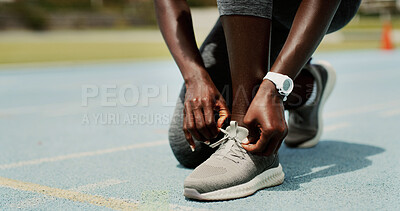 Buy stock photo Sports, shoes and hands of person on track for running, workout or training for race outdoor. Fitness, challenge and feet of athlete typing laces for exercise, marathon or competition at stadium.