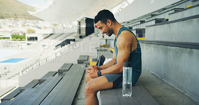 Buy stock photo Athlete, man and relax with phone at stadium for social media, fitness app and event agenda. Male person, rest and mobile for texting contact, sports progress results and information for tournament