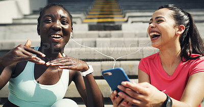 Buy stock photo Music, fitness and girl friends with phone for listening to playlist, networking or social media. Outdoor, sports and female athletes on break streaming album on mobile app with cellphone on stairs.