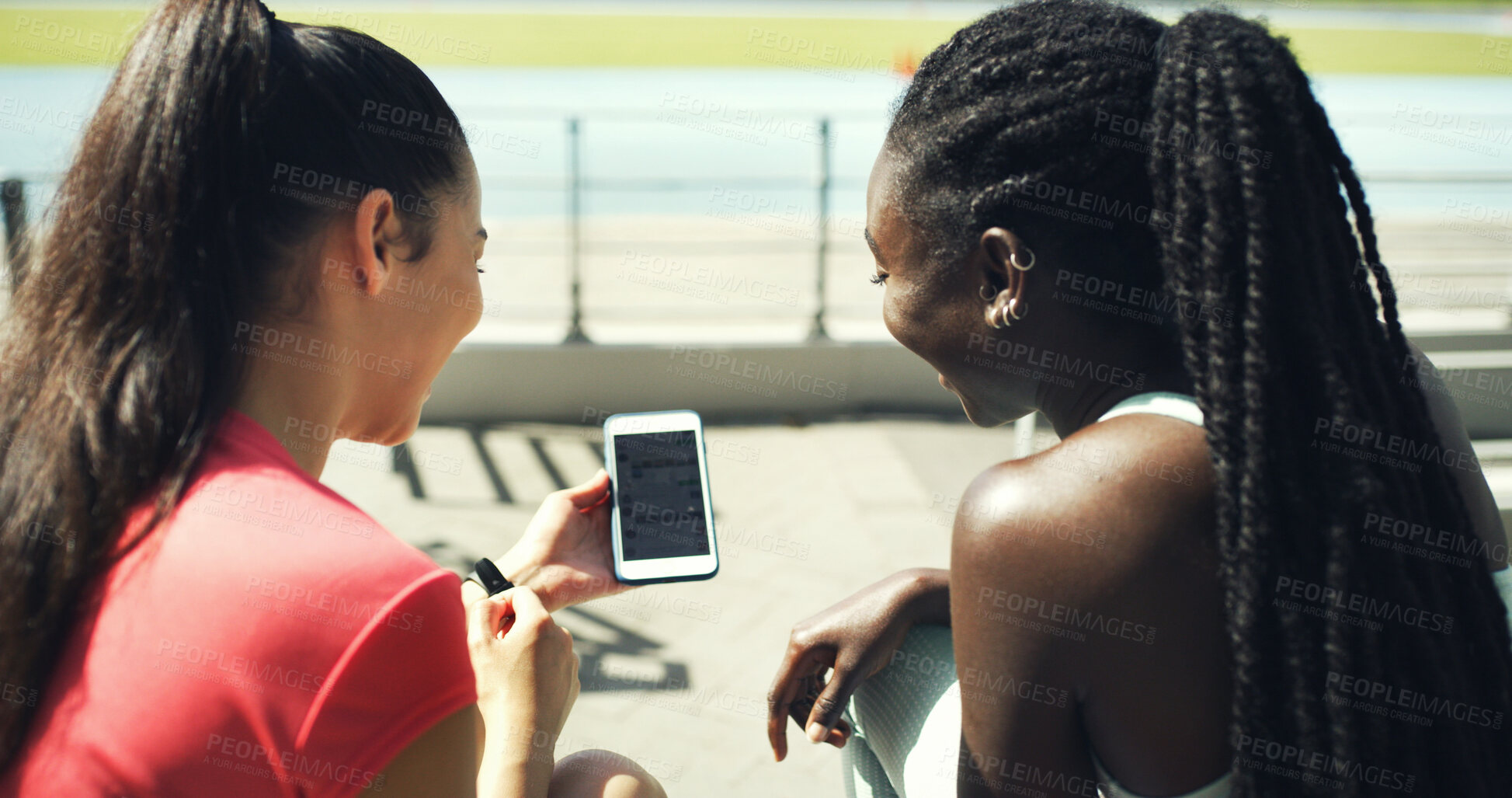 Buy stock photo Runner, phone and reading with friends in stadium for training schedule, team and sports stats. Fitness app, competition, lap times and exercise guide with women on race track for tracking progress