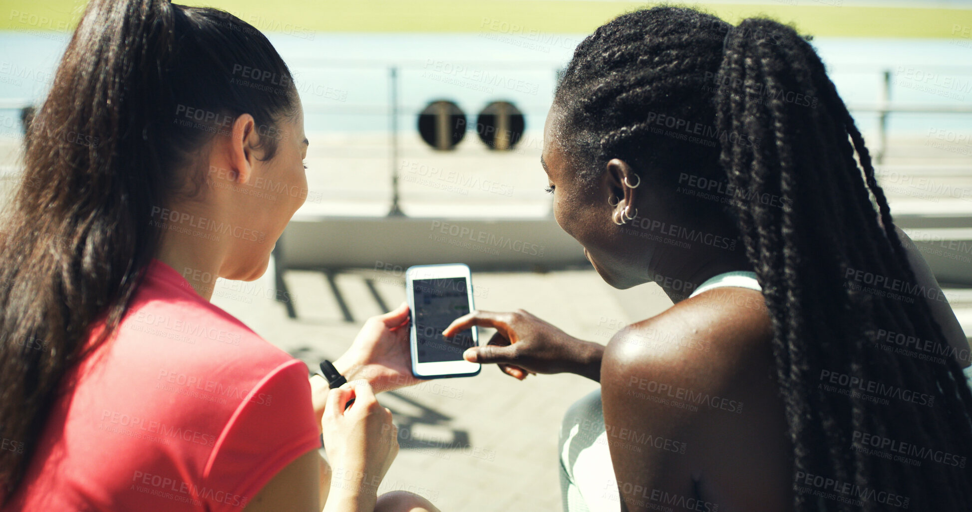 Buy stock photo Runner, phone screen and scroll with friends in stadium for training schedule, team or sports. Fitness app, communication and exercise guide with women on race track for social media and online chat