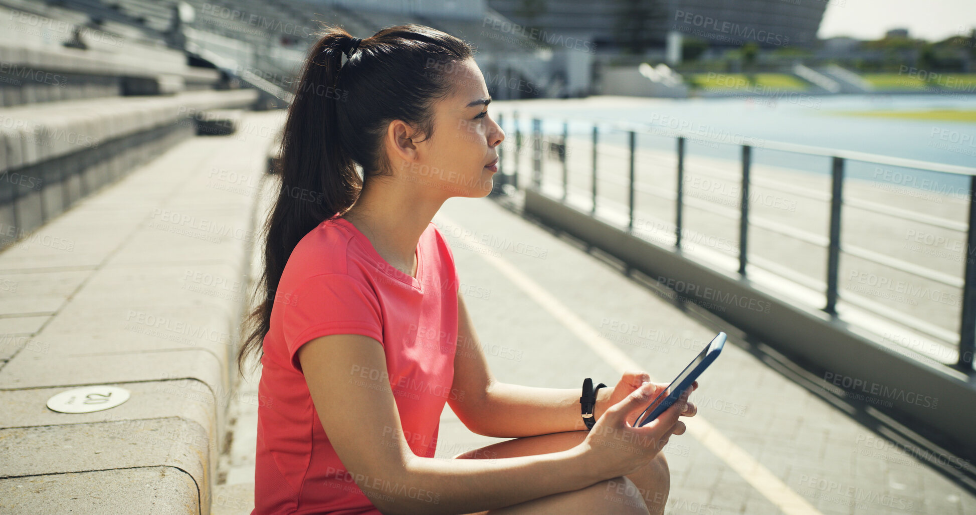 Buy stock photo Athlete, woman and thinking with phone at stadium for social media, fitness app and event agenda. Female person, resting and mobile for texting, sports progress results and information for tournament