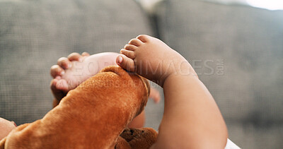 Buy stock photo Closeup, feet and learning with baby on sofa for relax, child development and growth. Comfortable, explore and motor skill milestone with kid in living room of home for cute, playful and games