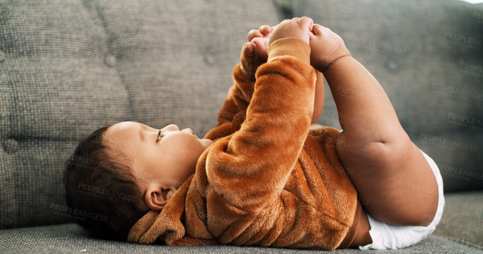 Buy stock photo Curious, feet and learning with baby on sofa for relax, child development and growth. Comfortable, explore and motor skill milestone with kid in living room of home for cute, playful and games
