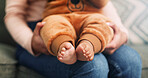 Parent, hands and sofa with baby feet for childcare growth, youth or development in home. Closeup, parenthood or childhood with infant toes or footprint for love, support or health and wellness