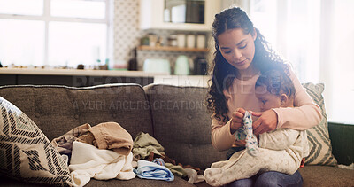 Buy stock photo Woman, baby and folding laundry on sofa with hygiene, care and bonding with love in lounge at home. People, mother and infant child with clean clothes, fabric and organizing on couch at family house