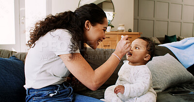 Buy stock photo Mother, happy and feeding baby on sofa for nutrition, growth and wellness with bonding in home. People, mom and infant child with love, smile or eating food for diet in living room at family house