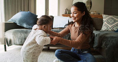 Buy stock photo Home, holding hands and mother with baby, help and bonding together in living room. Apartment, family and happy mama with kid, support and child development with steps, growth or learning with parent