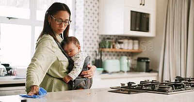 Buy stock photo Baby, cleaning and mother in kitchen with cloth for chores, housework juggle or wiping counter. Bacteria, dirt or disinfection with parent and sleeping infant in home together for multitasking