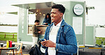 Happy, food truck and man with phone in city on social media, internet and website on weekend. Customer review, outdoor and person typing on smartphone by mobile cafe, restaurant and vendor rating